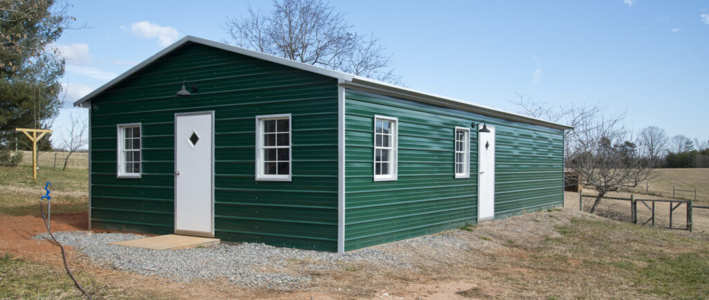 Green metal structure with white doors and trim. New Freckled Farm Soap Company soap facility.